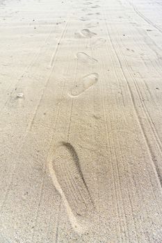 foot prints in the sand near sea beach in bali, indonesia