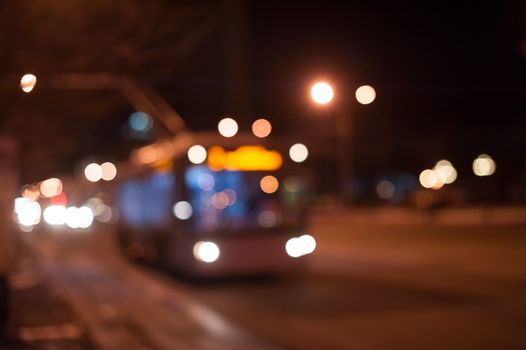 trolley bus on the night city street.