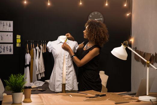 Young fashion designer working on her atelier