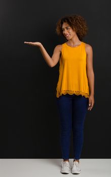 Beautiful African American woman showing something in her hand