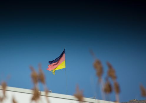 A waving german flag, which is not in its best shape. Symbolic.