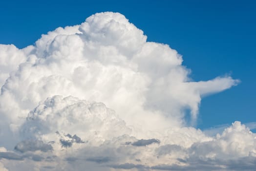 Cumulus clouds forming on blue summer day