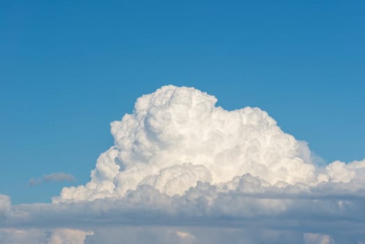 Cumulus clouds forming on blue summer day