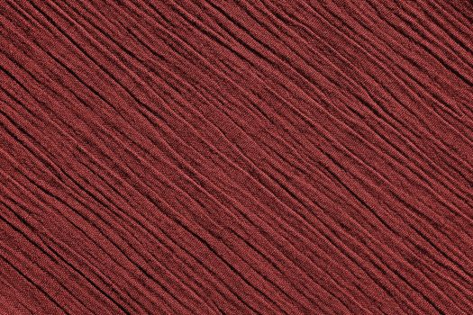 Red crinkled fabric with irregular diagonal lines textile abstract background texture