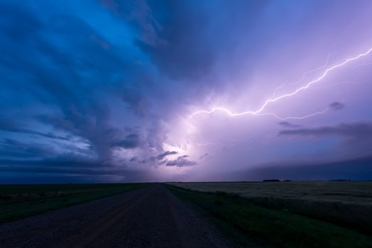 Lightning across the sky above a road in the prairies