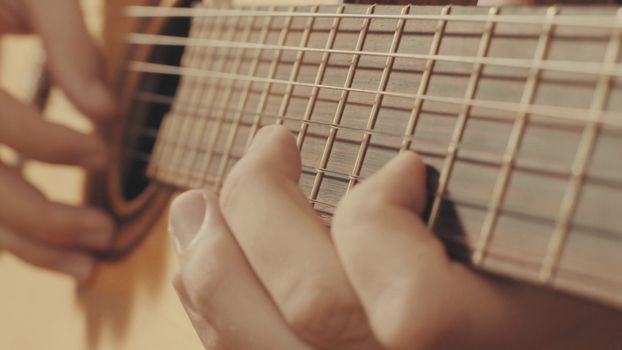 Hands of guitarist playing a guitar. Close-up
