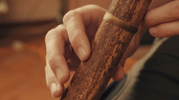 Hands of musician plays the flute. Close up