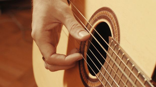 Hands of guitarist playing a guitar. Close-up
