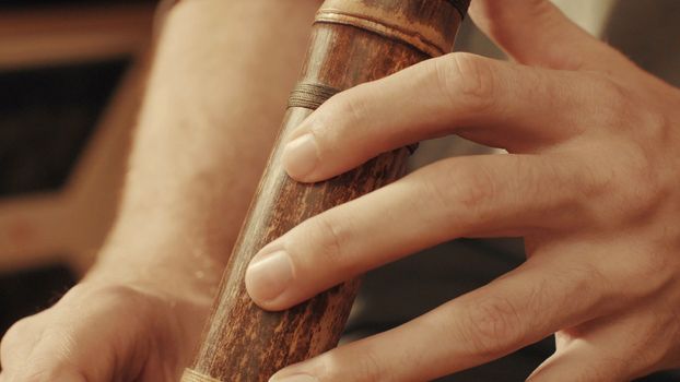 Hands of musician plays the flute. Close up