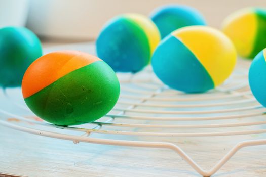 Easter eggs painted by hand yellow and blue lie on lattice