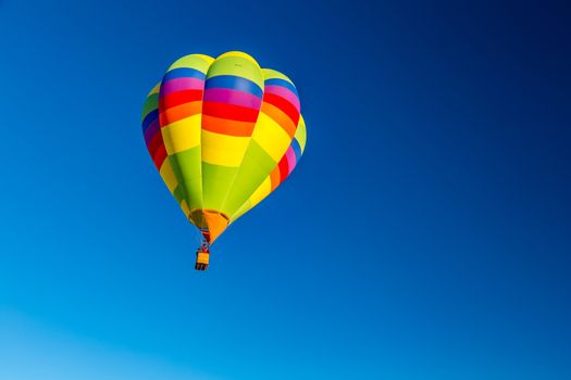 Colorful hot air balloons fly over the glistening gypsum dunes at White Sands National Monument during the 2016 Balloon Invitational.