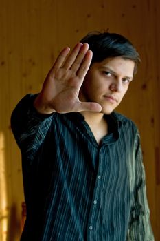 Young man showing a sign "stop"