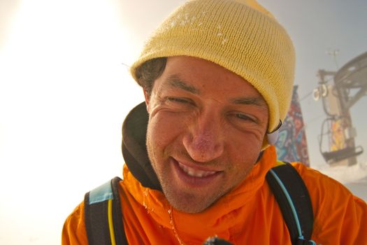 Funny portrait of sportsman in orange parka