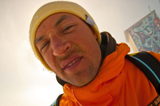 Funny portrait of sportsman in orange parka