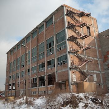 discarded ruin with old windows and wall, industrial window in concrete wall