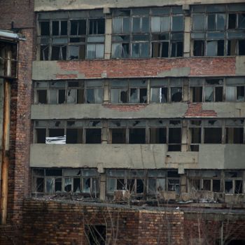 discarded ruin with old windows and wall, industrial window in concrete wall