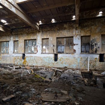 discarded ruin with old windows and wall, industrial window in concrete wall