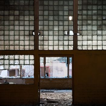 discarded ruin with old windows and wall, industrial window in concrete wall