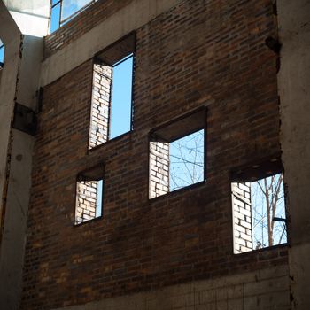 discarded ruin with old windows and wall, industrial window in concrete wall