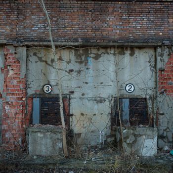 discarded ruin with old windows and wall, industrial window in concrete wall