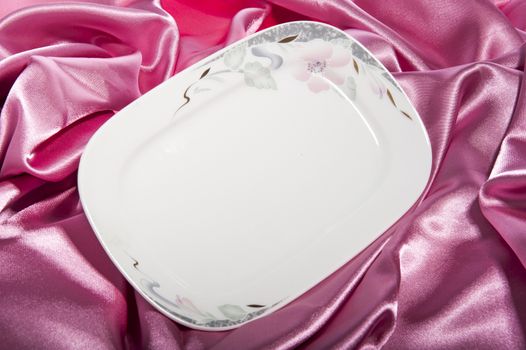 a elegant ceramic plate on a  fabric backgroun