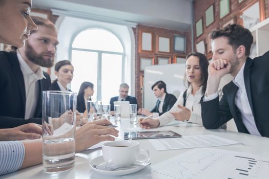 Business partners discussing documents and ideas at meeting