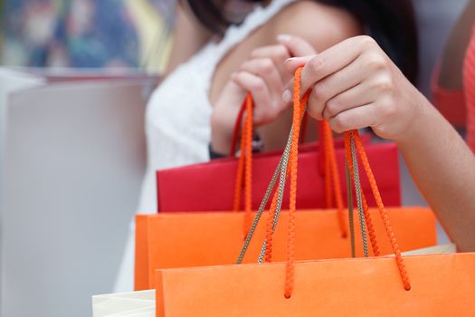 Women showing their shopping bags close-up view