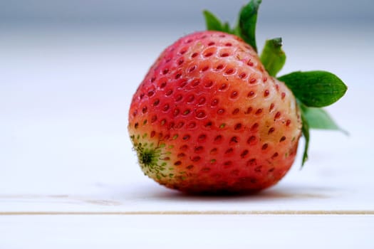 Close Up One Red Strawberry on the Table Wood