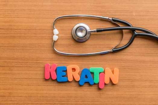 keratin colorful word with Stethoscope on wooden background