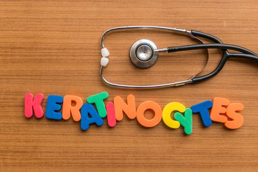 keratinocytes colorful word with Stethoscope on wooden background