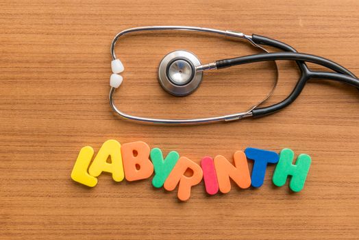 labyrinth colorful word with Stethoscope on wooden background