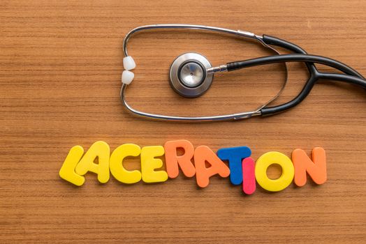 laceration colorful word with Stethoscope on wooden background