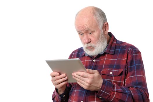 Senior bald and bearded white haired man astonished with something at screen of tablet computer, isolated on white background