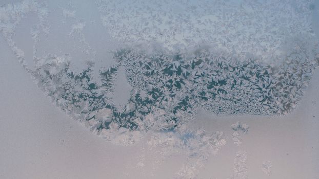 Ice pattern on the frozen window. Winter.