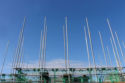 Low angle view of scaffolding poles on building site.