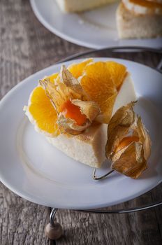 Cheese cake decorated with oranges and physalis.