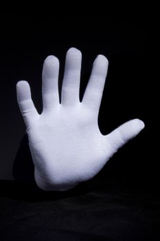Hand in glove with white cloth gesturing