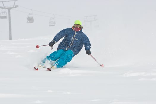 Young man skiing in snowstorm