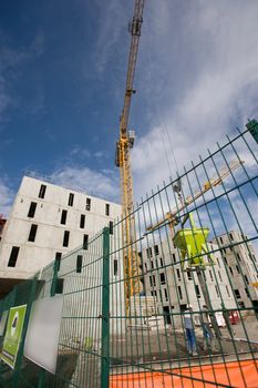 the construction crane and the building against the blue sky, France
