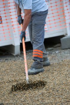 Construction workers sweeping in the installation, Gravel