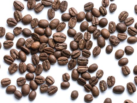 Coffee beans closeup on white background. Roasted coffee beans top view