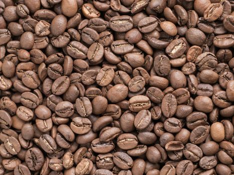 Coffee beans closeup background. Roasted coffee beans texture top view