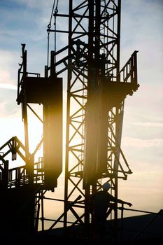 Construction worker, crane and building at sunset, France
