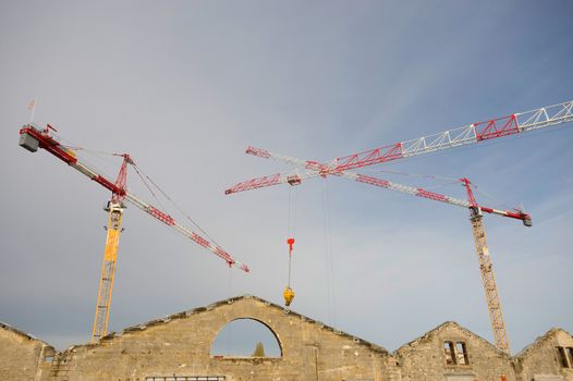 the construction crane and the building against the blue sky, France
