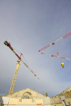 the construction crane and the building against the blue sky, France
