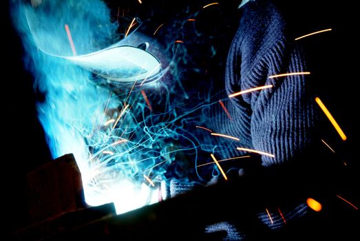 Arc welder with welding sparks on black background