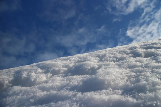 white snow on mountain slope against the blue sky low angle view