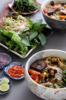 Vietnamese food, bun rieu and canh bun, is popular street food cook from crab, tofu, vermicelli eat with shrimp paste, vegetables, is delicious and cheap dish