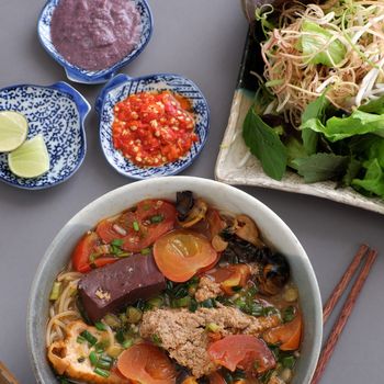 Vietnamese food, bun rieu and canh bun, is popular street food cook from crab, tofu, vermicelli eat with shrimp paste, vegetables, is delicious and cheap dish