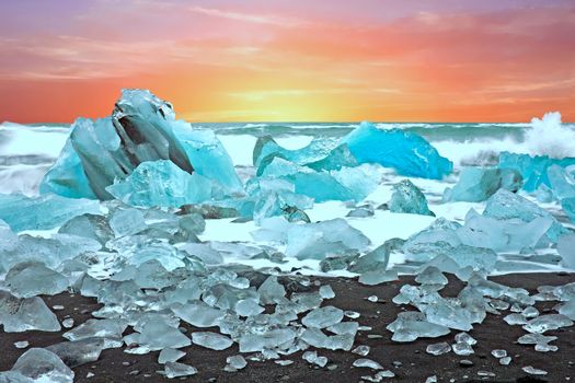 Ice rocks on a black sand beach at Jokulsarlon in Iceland at twilight